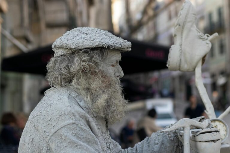 A living statue performer in Porto, Portugal, depicting a shoemaker with intricate stage makeup.