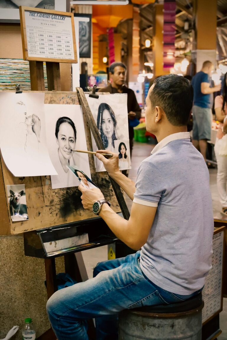 A talented street artist sketches portraits of people in a bustling Bangkok market.